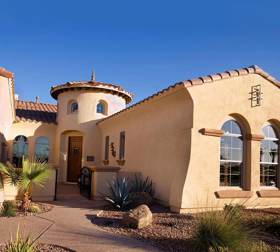 Stucco home exterior with clay roof tiles, shown as residential planning context.